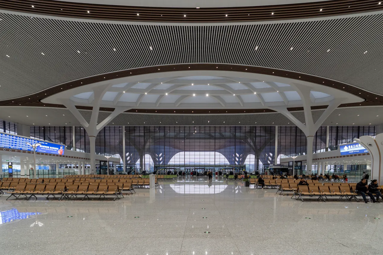 Seating rows and departure boards in the waiting hall at Chongqing East station.