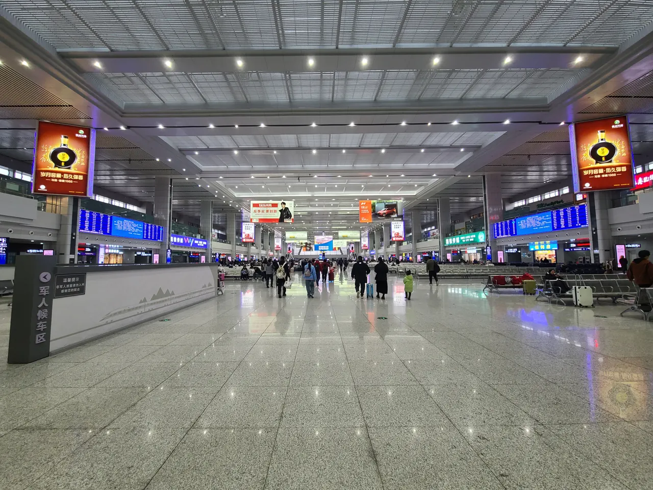 Departure boards, numbered gates and rows of seats in Chongqing North station.