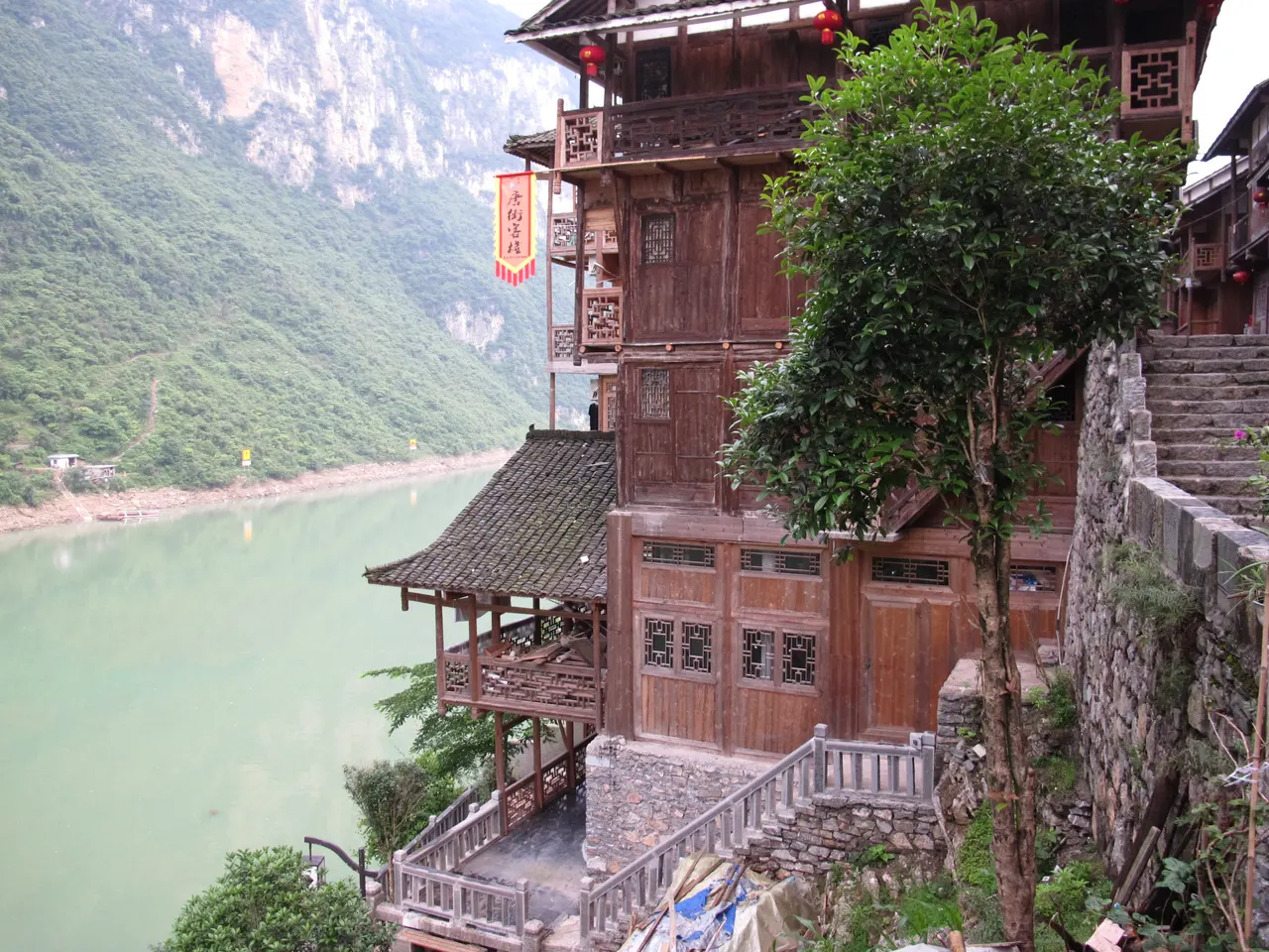 Timber houses, tiled roofs and stone steps above the Wu River at Gongtan