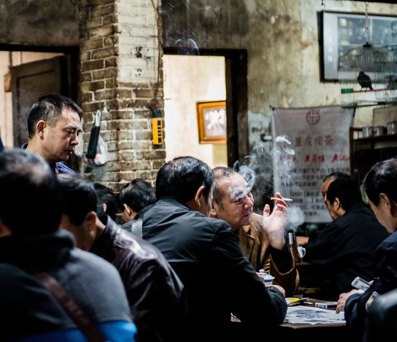 People at tables in Chongqing’s Jiaotong teahouse