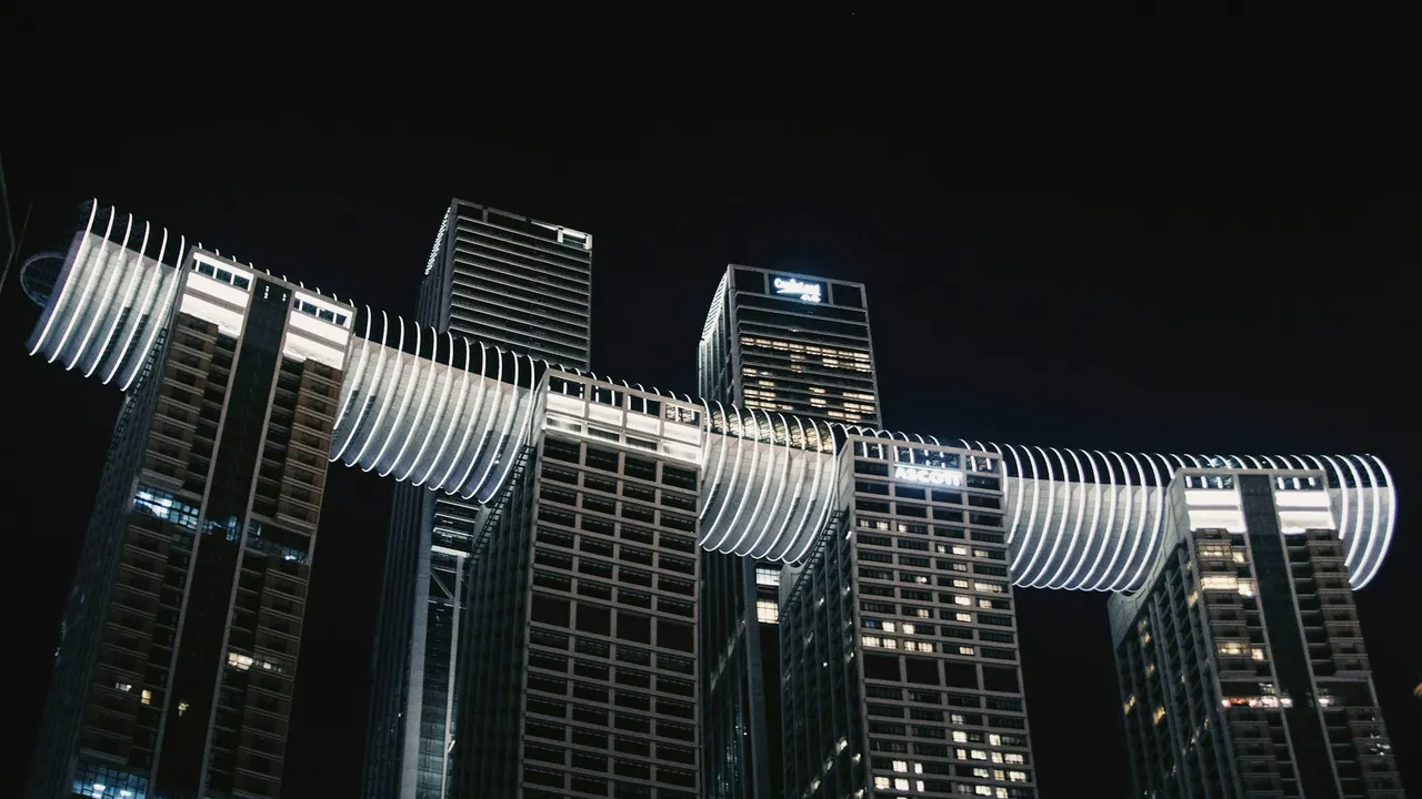 Raffles City towers illuminated at night in Chongqing