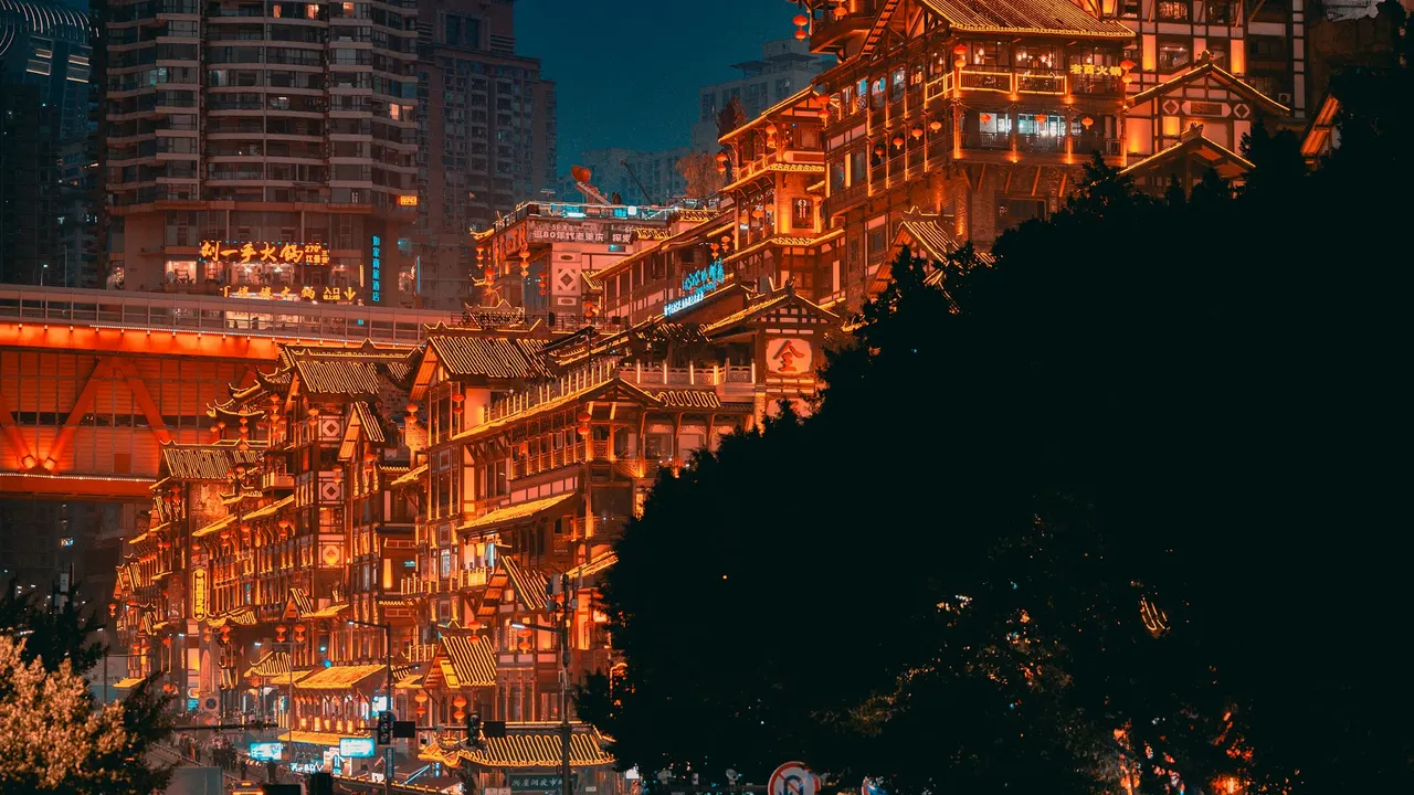 Hongya Cave’s illuminated buildings and traffic at night in Chongqing