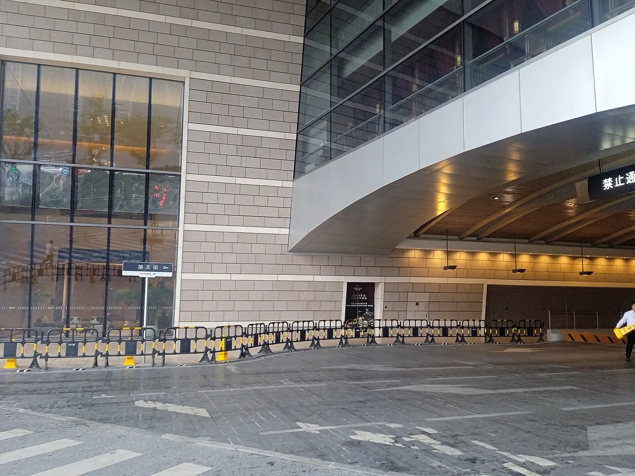A marked crossing on Jiesheng Street beside a modern building in Chongqing