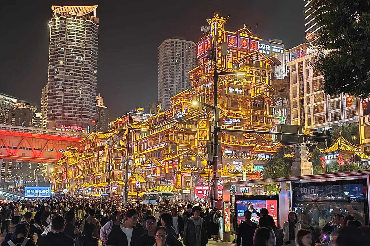 Hongyadong’s illuminated stacked roofs above Jiabin Road, with Qiansimen Bridge on the left