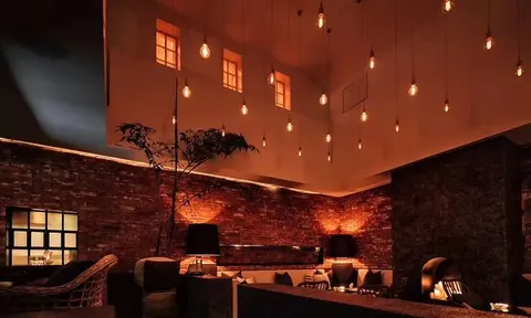 Hanging lamps and low tables inside Flavor Tiki on 9th Street
