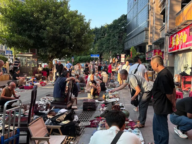 Daytime shoppers and outdoor stalls outside Panda Antique City.