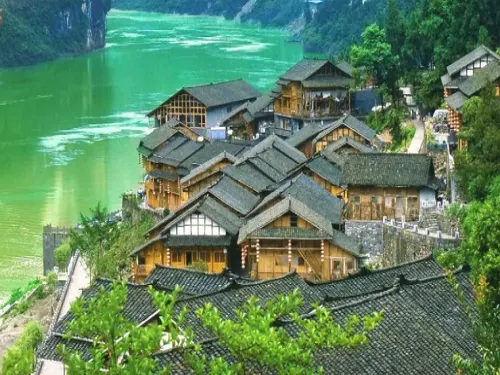 Gongtan's overlapping wooden houses and tiled roofs beside the Wu River