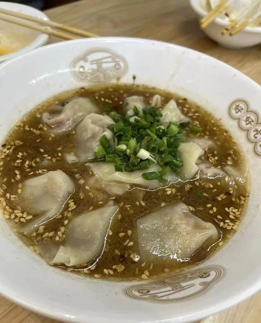 Wontons in broth with sesame and herbs