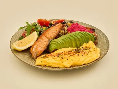 A brunch plate with an omelette, sliced avocado and a fish fillet at mates’ Star68 branch.