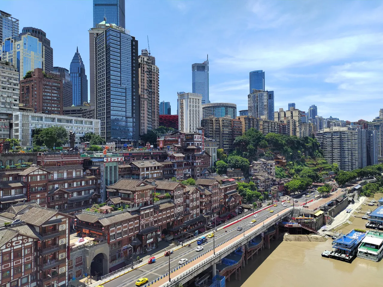 Daytime view of the multi-level wooden buildings of Hongya Cave from Qiansimen Bridge.