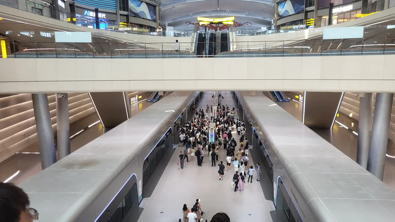 Passengers between shuttle trains at the T3B satellite terminal’s airport train platform.