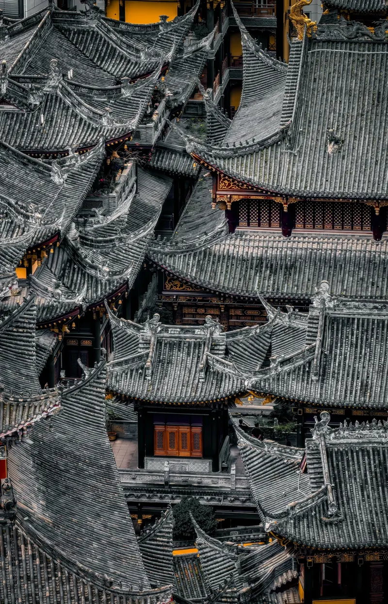 Overlapping grey tiled roofs and small courtyards inside Luohan Temple, seen from above
