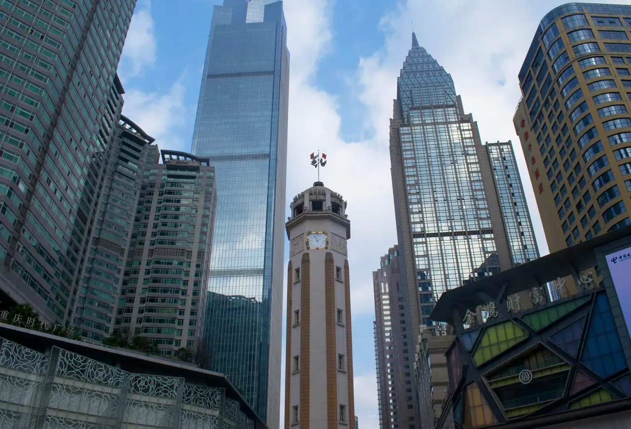 The Jiefangbei Liberation Monument stands between Chongqing's tall city-center buildings.