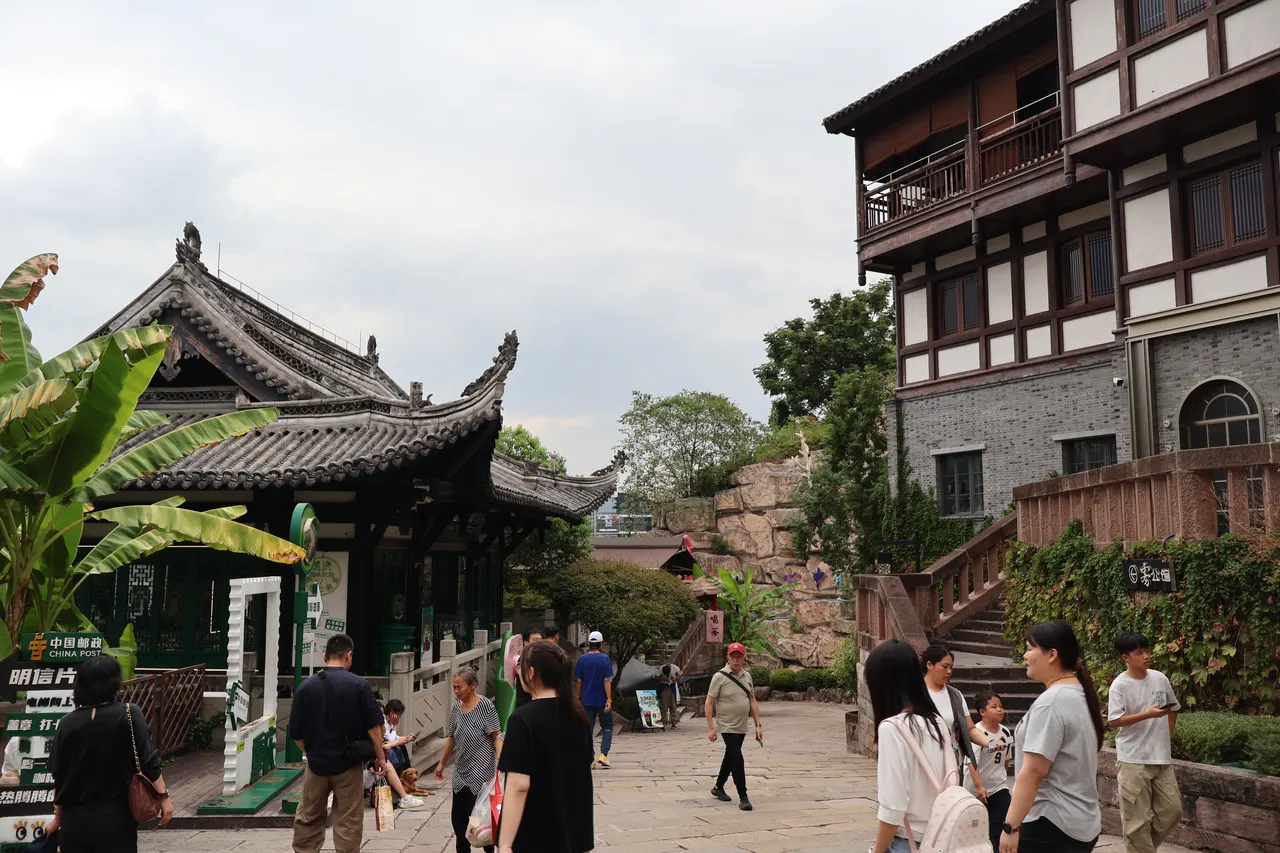 Visitors on a stone-paved street among tiled buildings in Ciqikou