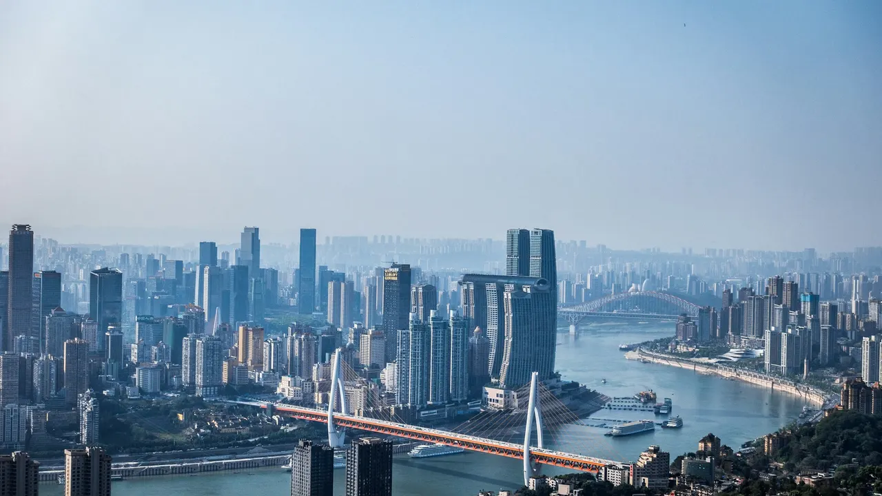 Chongqing’s skyline and river bridges under a blue daytime sky