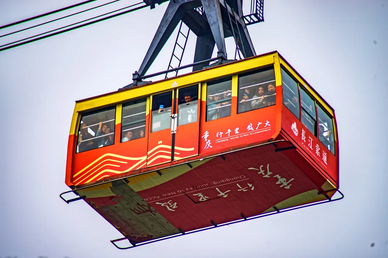 Red and yellow Yangtze River Cableway cabin carrying passengers
