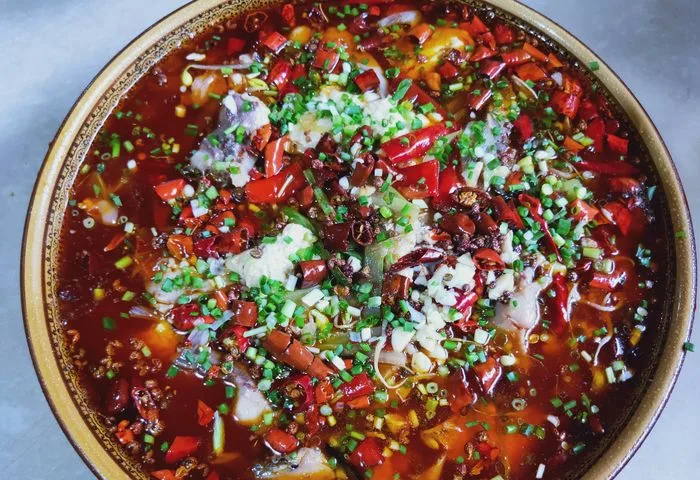 Spicy fish and soft tofu topped with peppers and spring onion at Youyuan
